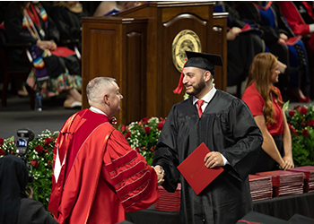 Western Kentucky University graduate receiving diploma at a College Recognition Ceremony 