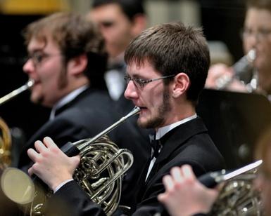 Student playing the horn.