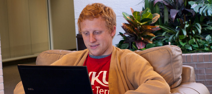 Young man working on a laptop in a casual setting