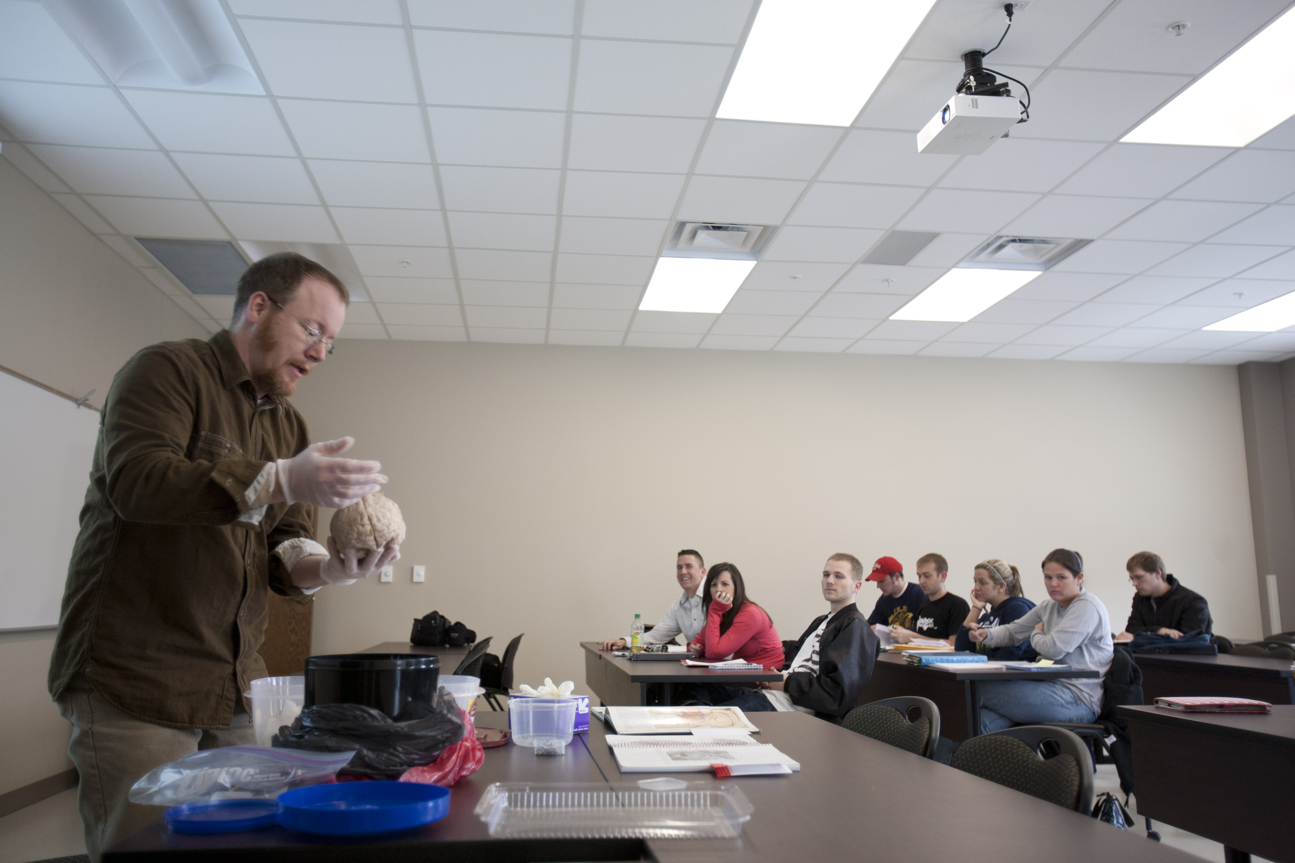 Dr. Hahn shows students a brain in class.