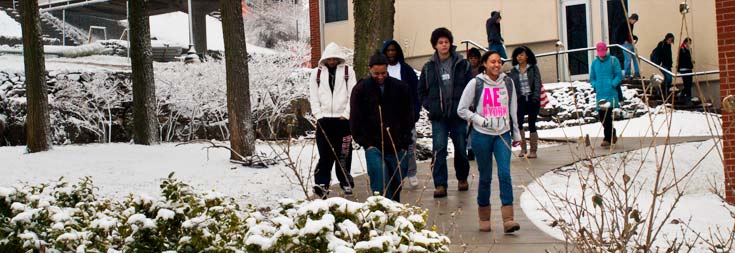 students walking on campus with snow