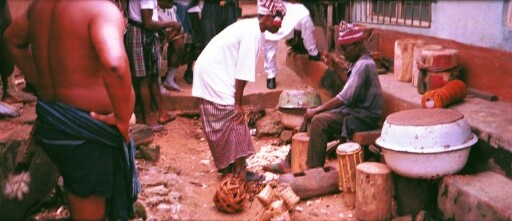 A carver at work with some of his finished products around