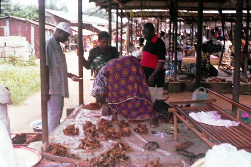 A member of the research team buying something from the market