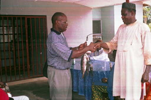 The author receiving a gift of fish from one of the chiefs after the regatta