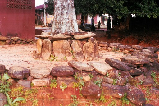 A tree shrine and a sacred space in the village plaza