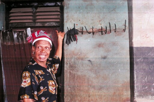 One of Iheukwumere's sons showing materials on the wall