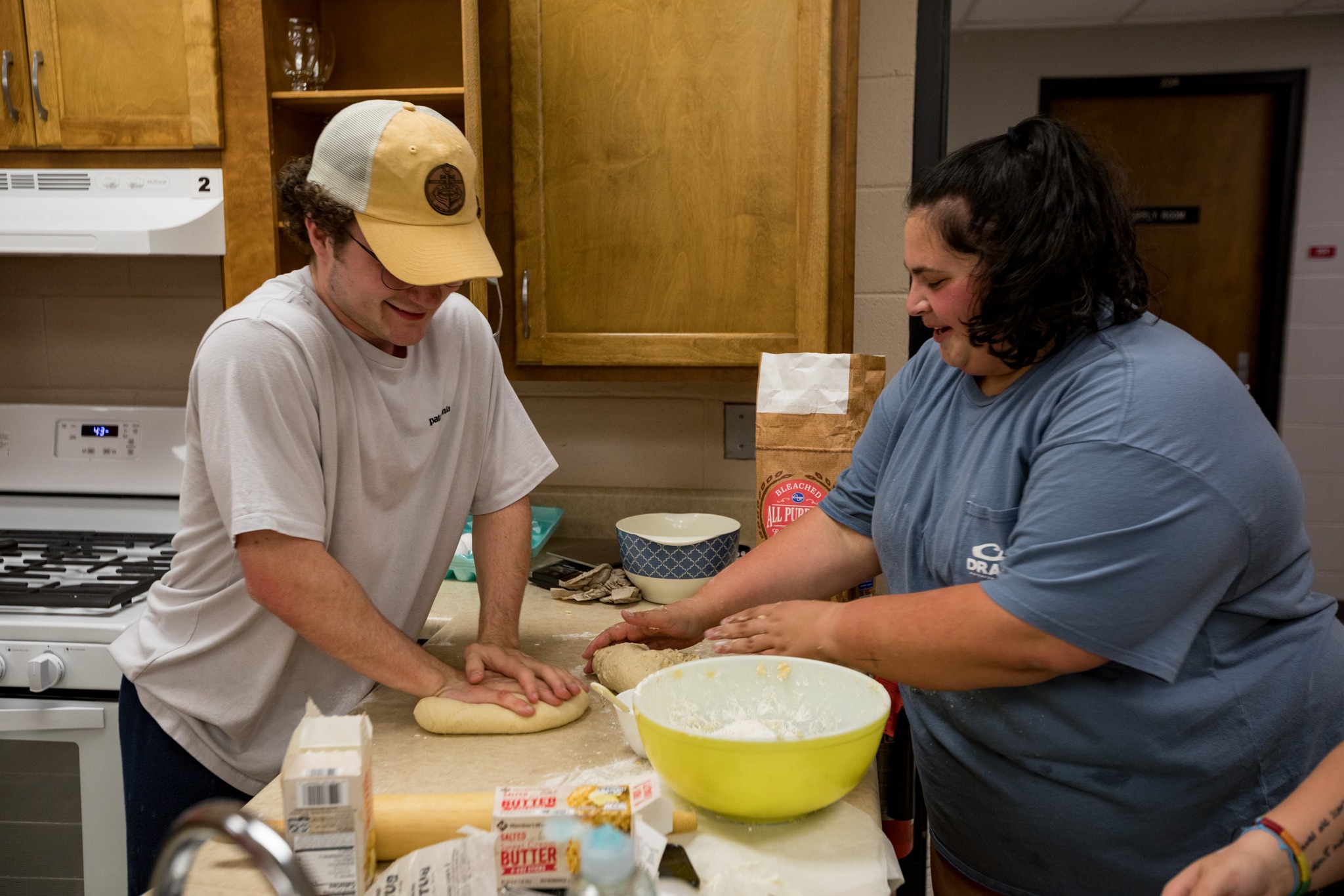 Two WKU students cook in a food lab.