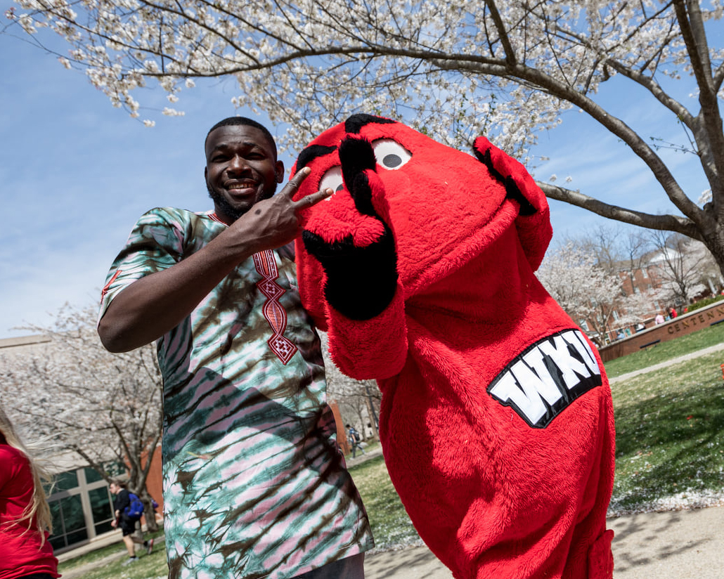 A WKU student poses with Big Red.
