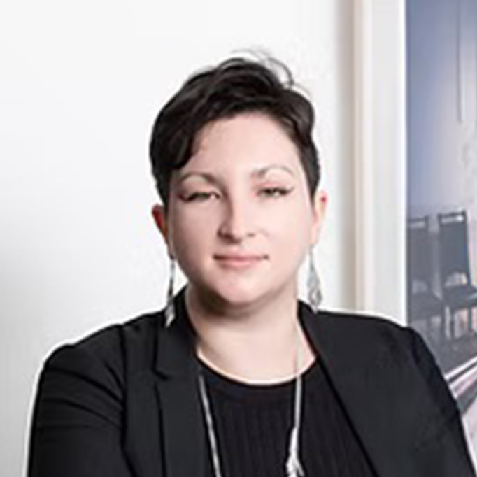 Woman with short black hair in a black blazer