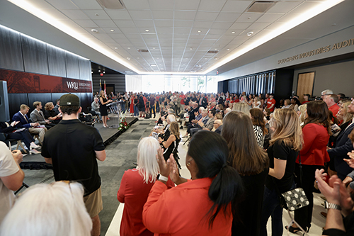 Guests listening to Amy Chandler at Chandler Hall dedication and ribbon cutting