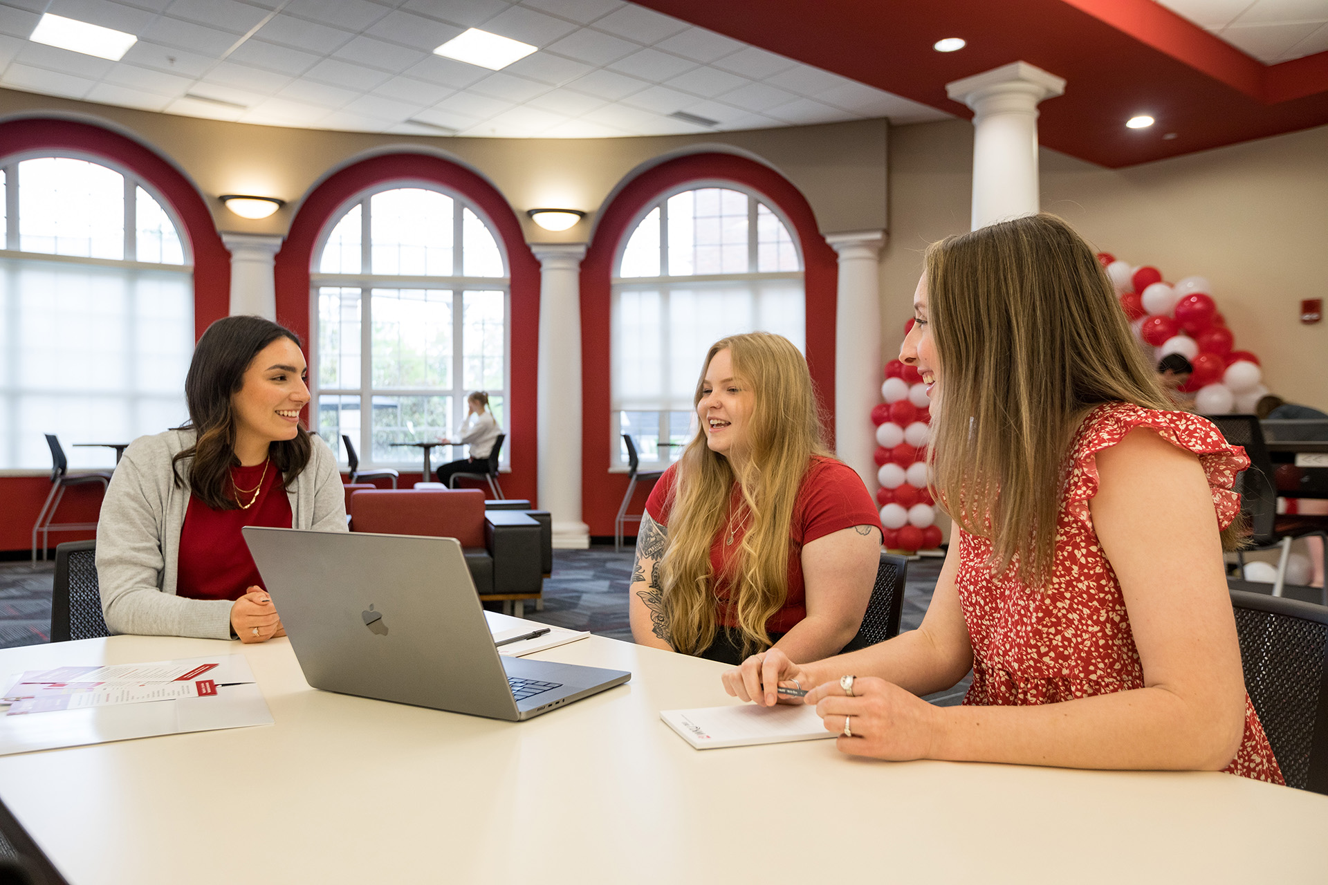 Three students working in the student success center.