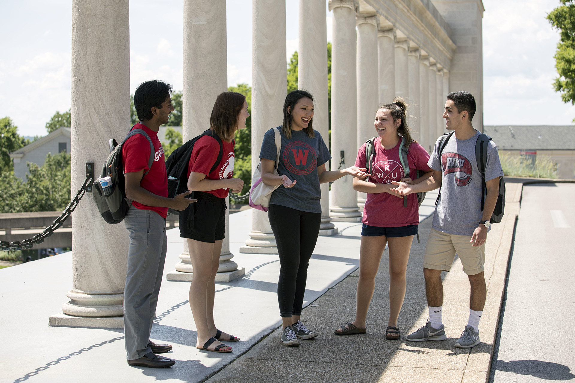 Five WKU students talking outside.
