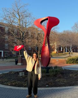 Student waving red towel