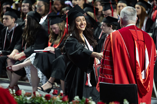 Western Kentucky University graduate shaking hands with President Caboni at a College Recognition Ceremony 