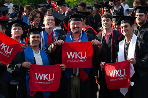 Commencement graduates displaying red towels at Topper Walk