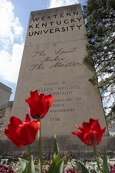 WKU pylon monument with red flowers