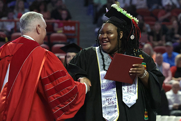 WKU Graduate shaking hands with President Caboni