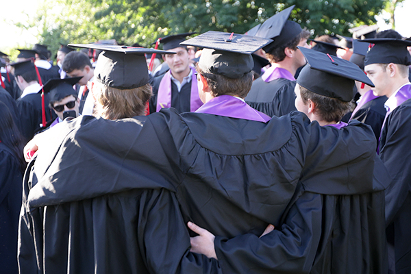 Graduates embracing for a group photo