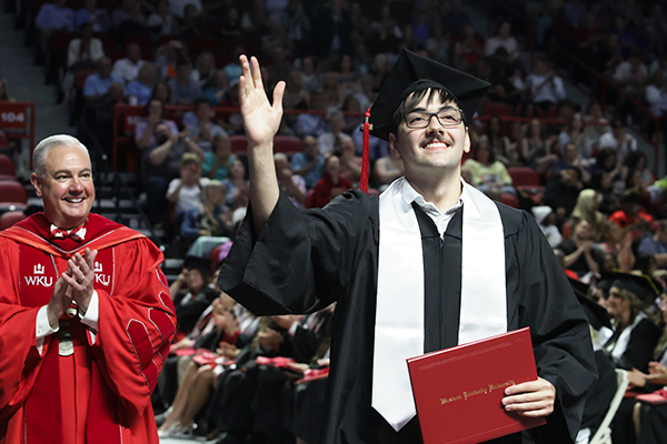 WKU graduate waving to crowd WKU graduate waving to crowd