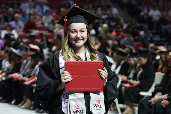 WKU graduate holding diploma cover