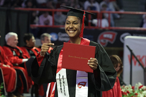 WKU graduate holding diploma cover