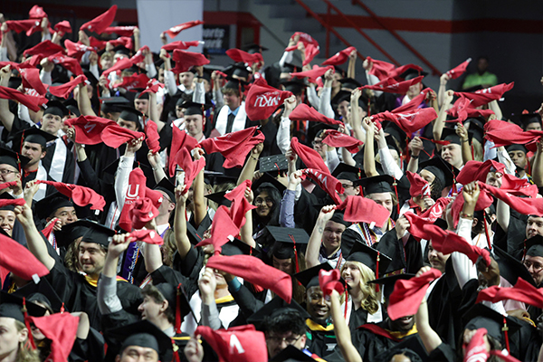 WKU graduates waving red towels during College Recognition Ceremonies