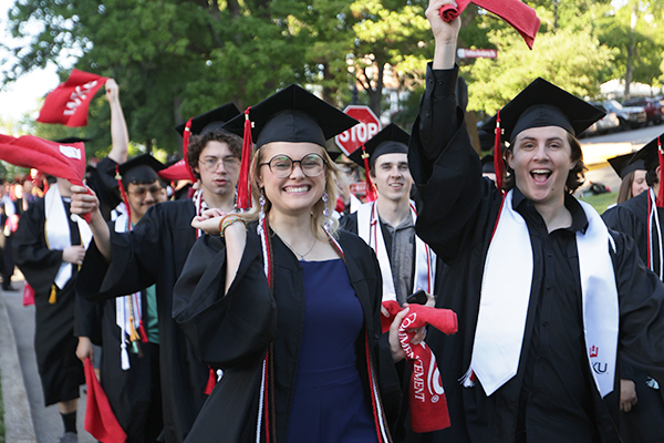 Graduates waving red towels during topper walk at WKU