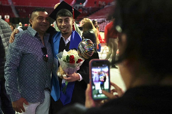 WKU graduate and family members taking a photo together