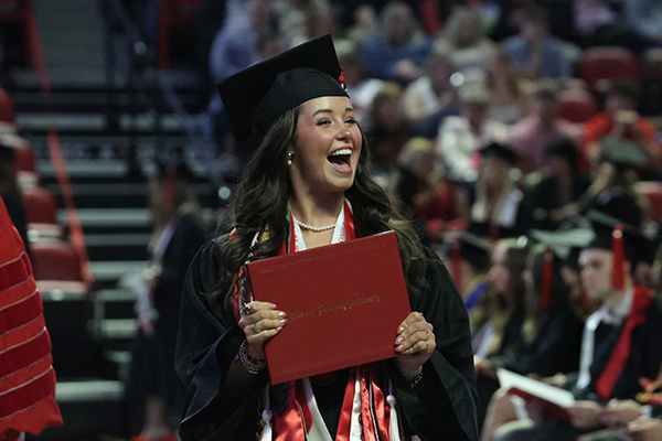 WKU graduate celebrating while walking the line