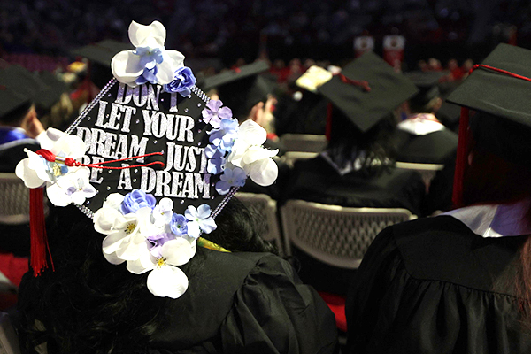 View of a WKU graduate's cap displaying flowers and the words don't let your dream just be a dream