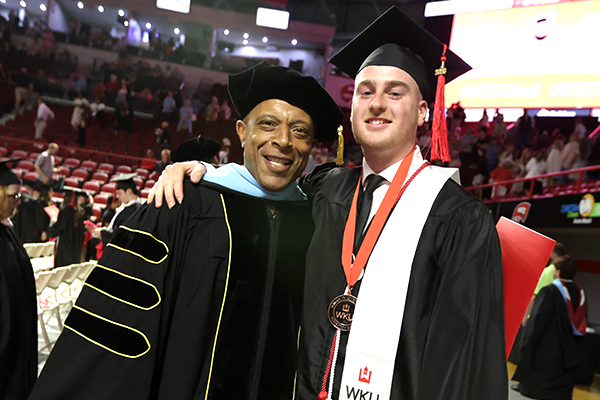 wku faculty member and graduate posing for a photo after graduation