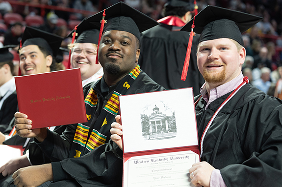 Graduates holding diplomas from WKU