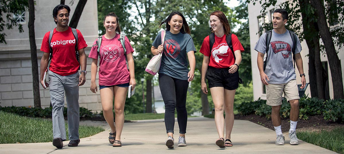 Students walking around campus in a group.