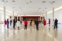 Director Newman addressing students in Garrett Conference Center ballroom (outside team offices) during warm-up before AFA out-rounds