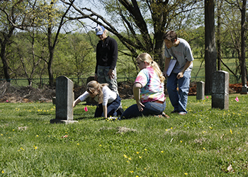 students and faculty documenting grave markers