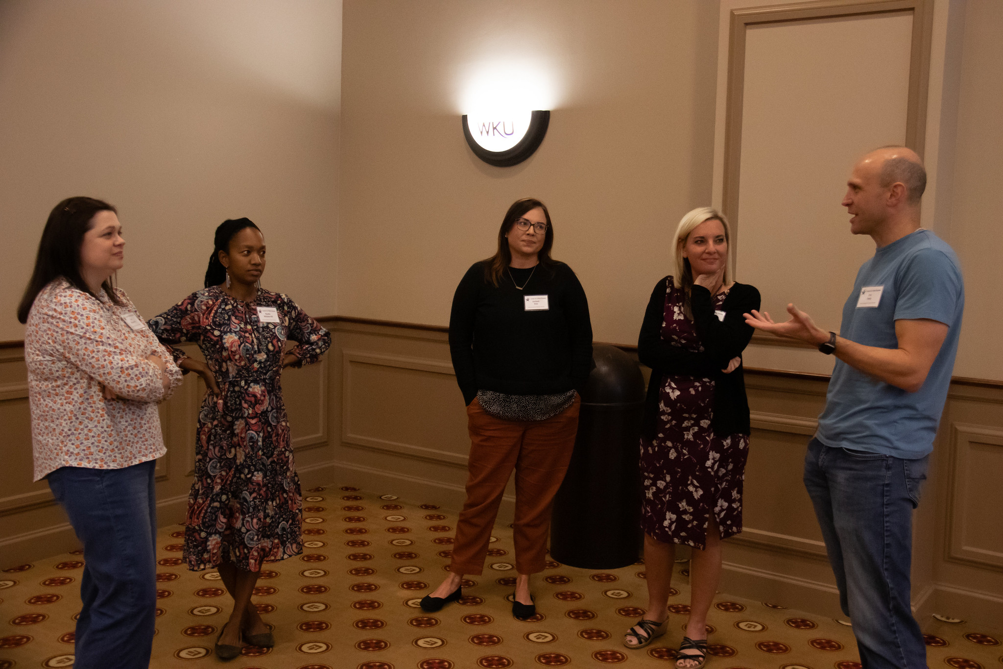 image of a group of people speaking in a large room