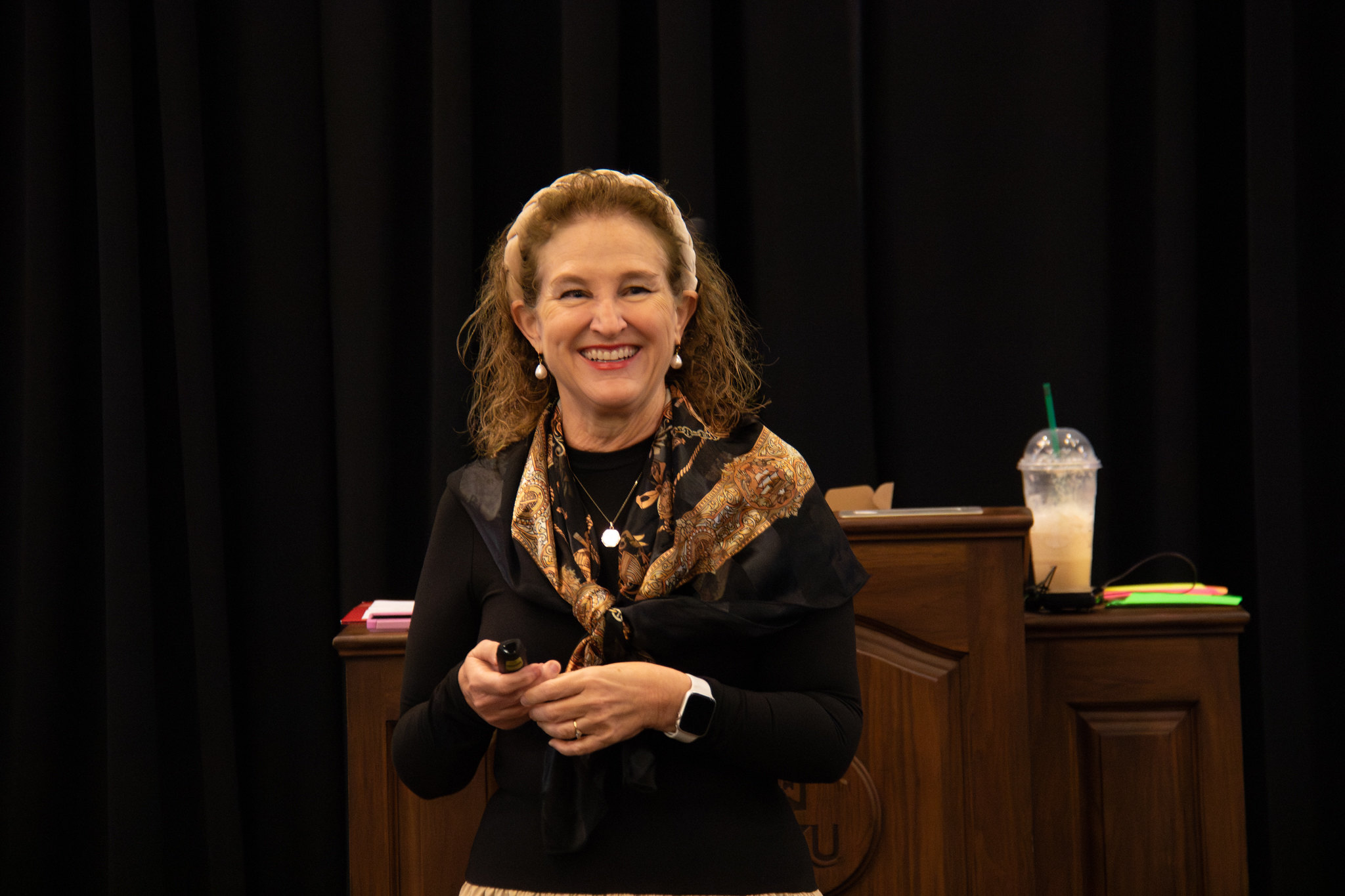image of woman smiling with her eyes directed above the camera