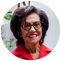 image of white woman with dark brown hair and glasses wearing a red top