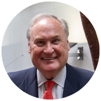 image of man wearing blue blazer and red tie