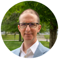 image of man wearing glasses and light blue blazer