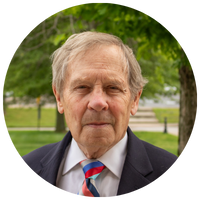 image of man with gray hair, a blazer, and a tie