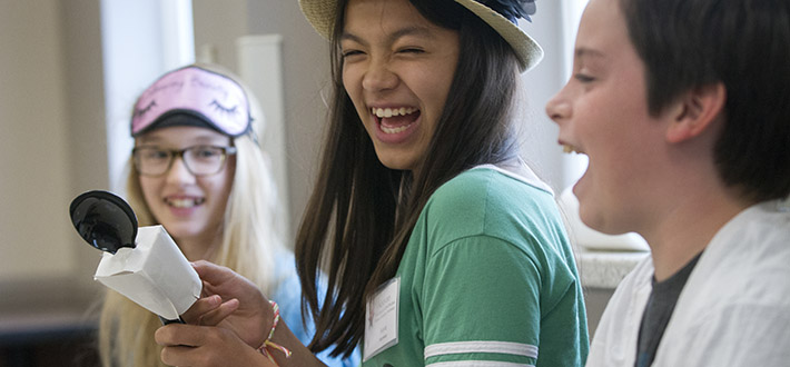 image of three middle schoolers laughing 