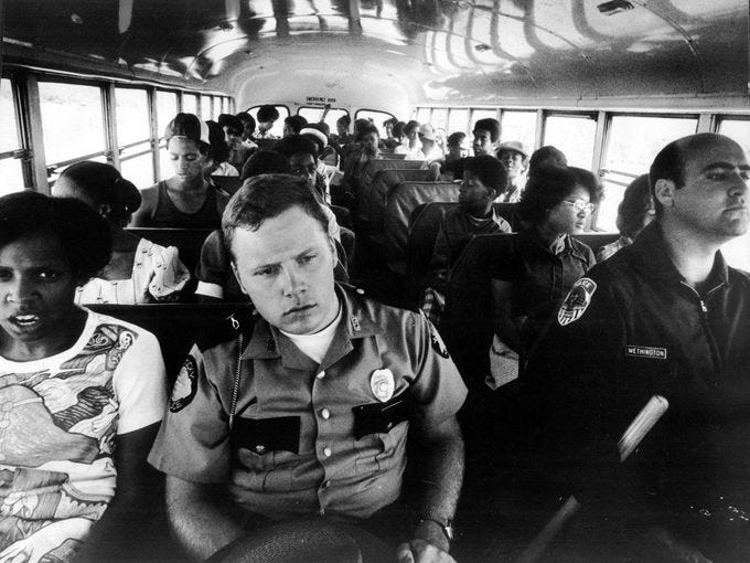 Busing students and police guards, Louisville, 1975