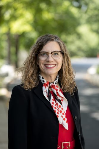 woman with glasses and scarf smiling