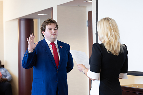 Student Regent Caden Lucas being sworn into office by Board of Regents Chair, Jan West