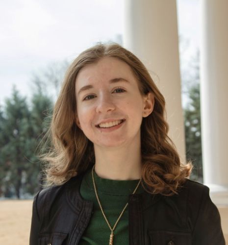 A headshot of a young woman in professional attire smiling