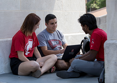 WKU Students working on a laptop outside