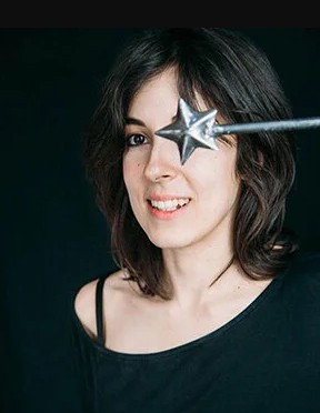 woman holding a metal star wand