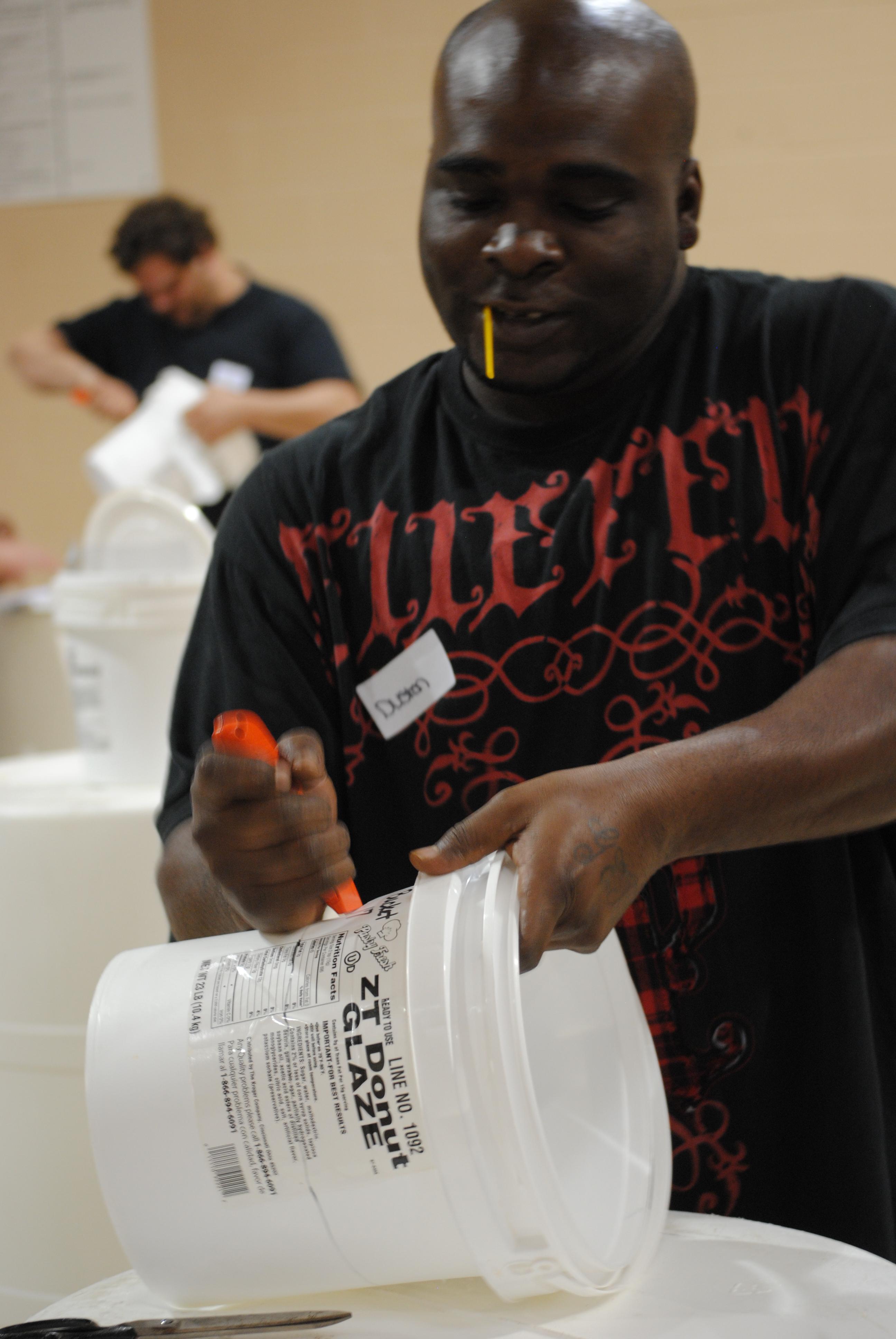 Parent cuts off bottom of bucket