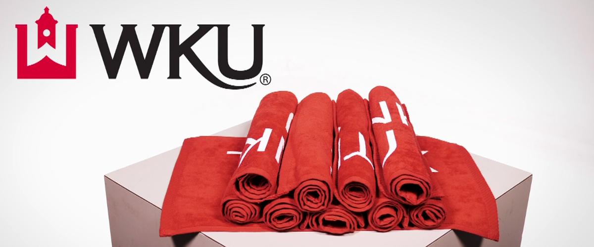 Collection of WKU Red Towels on a white podium on a white background.